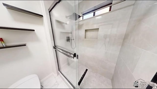 bathroom with toilet and walk in shower