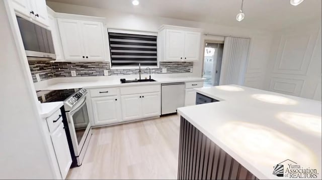 kitchen with decorative backsplash, white appliances, white cabinetry, and sink