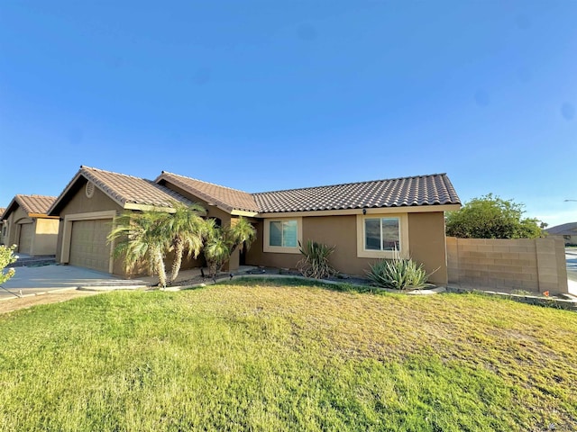 ranch-style home with a garage and a front lawn