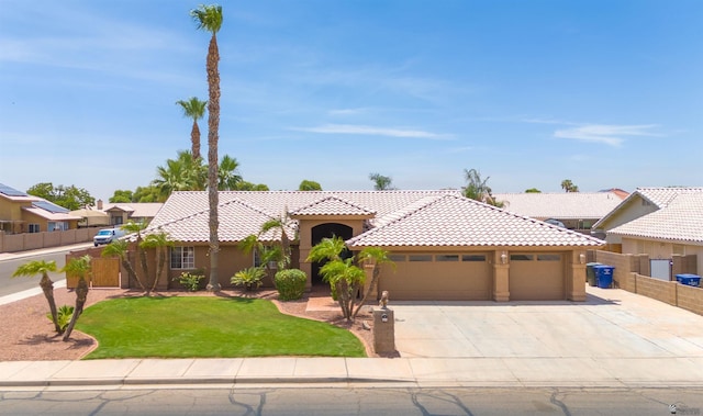 3875 W 26th St, Yuma, AZ 85364 - view of front of house featuring a tile roof, stucco siding, an attached garage, and concrete driveway