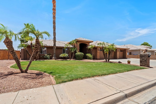 3875 W 26th St, Yuma, AZ 85364 - mediterranean / spanish-style home featuring an attached garage, concrete driveway, a tile roof, and stucco siding