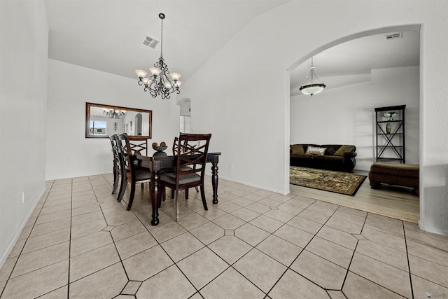 3875 W 26th St, Yuma, AZ 85364 - dining space featuring arched walkways, light tile patterned floors, lofted ceiling, and a chandelier