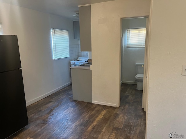 249 S 9th Ave, Yuma, AZ 85364 - kitchen featuring baseboards, freestanding refrigerator, dark wood finished floors, and decorative backsplash