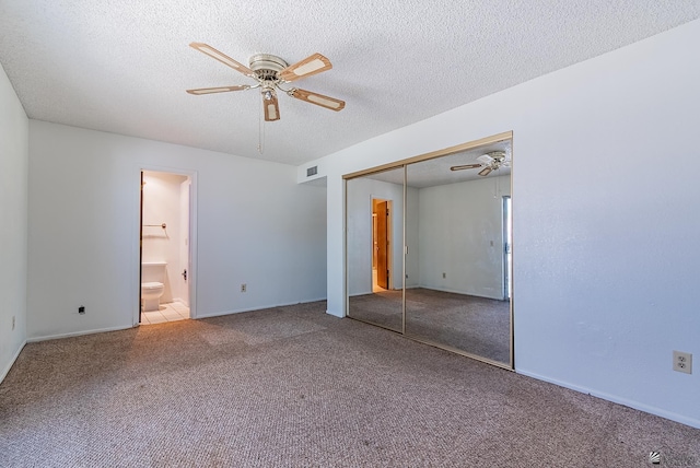 2231 S Elks Ln # 77, Yuma, AZ 85364 - unfurnished bedroom with carpet, a closet, a textured ceiling, and connected bathroom