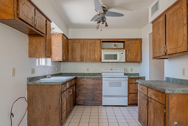 2231 S Elks Ln # 77, Yuma, AZ 85364 - kitchen with white appliances, brown cabinetry, a ceiling fan, and a sink