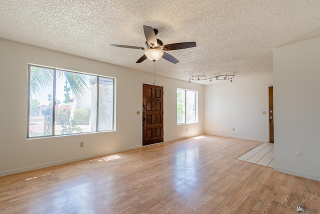 2231 S Elks Ln # 77, Yuma, AZ 85364 - spare room with a textured ceiling, a ceiling fan, and light wood-type flooring