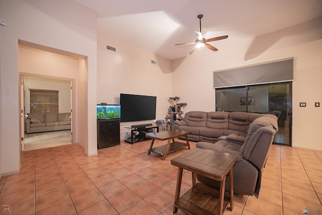 living room with a ceiling fan, visible vents, and light tile patterned floors
