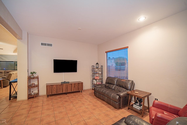 living area featuring recessed lighting, light tile patterned flooring, and visible vents