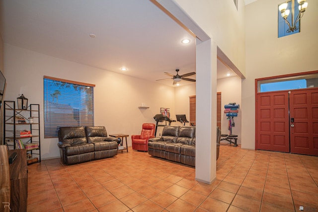 living area featuring ceiling fan with notable chandelier, recessed lighting, and light tile patterned flooring