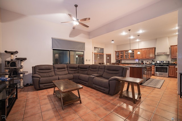 living area with ceiling fan and light tile patterned floors