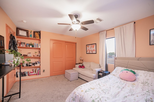 carpeted bedroom featuring visible vents, a ceiling fan, and a closet