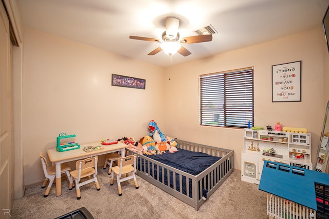 carpeted bedroom with ceiling fan and visible vents
