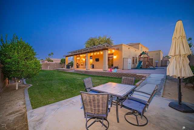 view of patio / terrace featuring a playground, outdoor dining area, and a fenced backyard