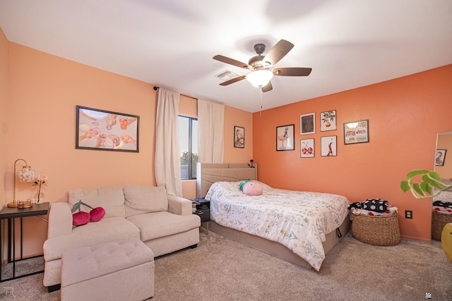carpeted bedroom with a ceiling fan and visible vents