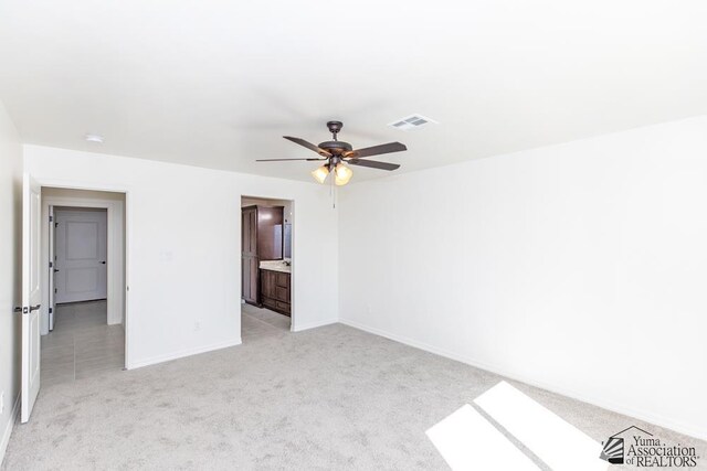12653 E 51st Pl, Yuma, AZ 85367 - unfurnished bedroom featuring light colored carpet, a ceiling fan, baseboards, and visible vents