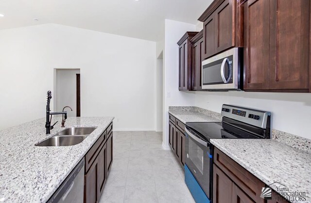 12653 E 51st Pl, Yuma, AZ 85367 - kitchen with dark brown cabinetry, light tile patterned flooring, light stone countertops, a sink, and stainless steel appliances