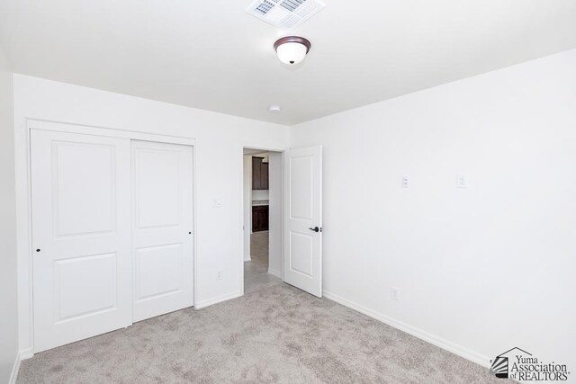 12653 E 51st Pl, Yuma, AZ 85367 - unfurnished bedroom with baseboards, visible vents, carpet, and a closet