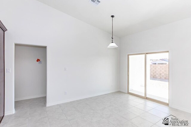 12653 E 51st Pl, Yuma, AZ 85367 - unfurnished room with light tile patterned floors, baseboards, lofted ceiling, and visible vents