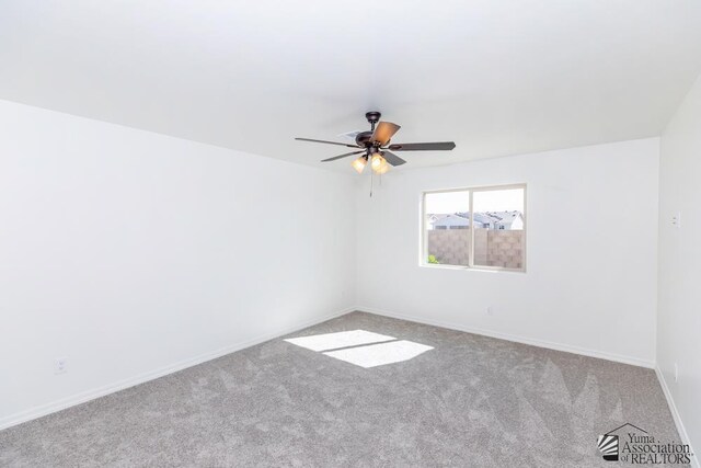 12653 E 51st Pl, Yuma, AZ 85367 - spare room featuring baseboards, carpet, and a ceiling fan