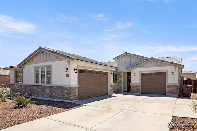 12160 S Drucilla Ln, Yuma, AZ 85367 - craftsman-style home with stone siding, an attached garage, concrete driveway, and board and batten siding