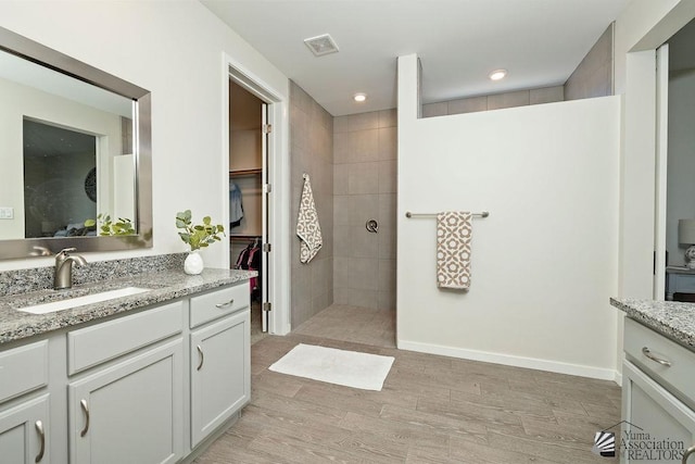 12160 S Drucilla Ln, Yuma, AZ 85367 - bathroom with vanity, a walk in shower, wood finished floors, recessed lighting, and a walk in closet