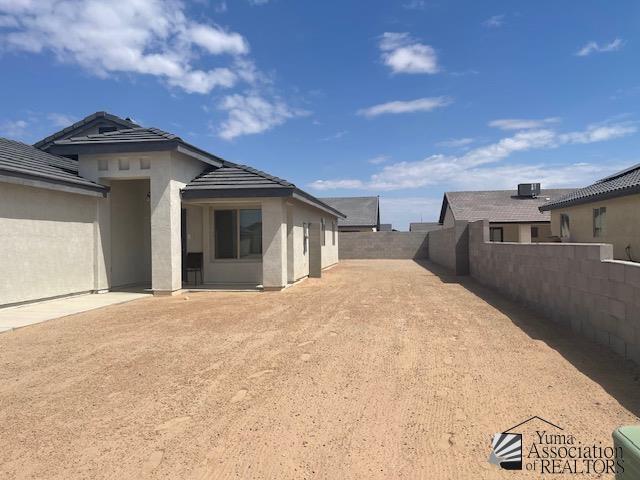4680 E San Pedro St, San Luis, AZ 85336 - view of home's exterior featuring a fenced backyard, stucco siding, and a tiled roof