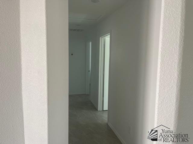 4680 E San Pedro St, San Luis, AZ 85336 - corridor featuring baseboards and tile patterned floors