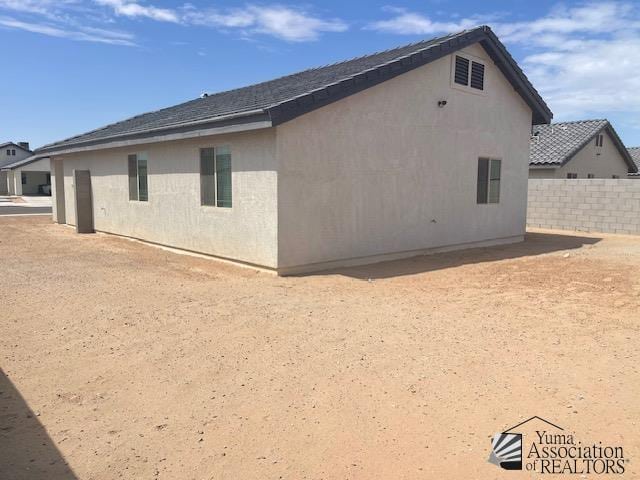 4680 E San Pedro St, San Luis, AZ 85336 - view of side of home with stucco siding and fence