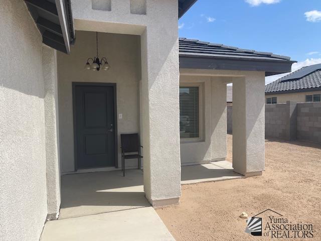 4680 E San Pedro St, San Luis, AZ 85336 - doorway to property featuring fence and stucco siding