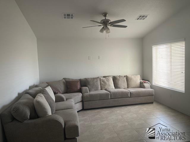 4680 E San Pedro St, San Luis, AZ 85336 - living area with light tile patterned floors, lofted ceiling, a ceiling fan, and visible vents