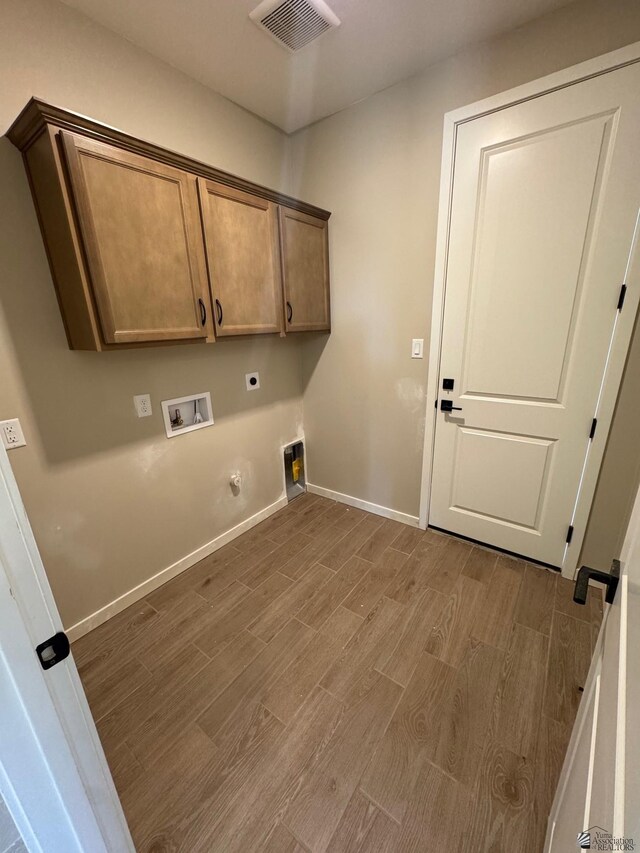 laundry area with hookup for an electric dryer, visible vents, wood finished floors, cabinet space, and hookup for a washing machine