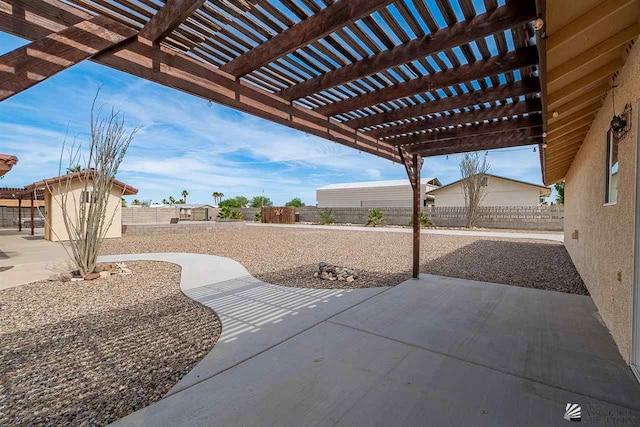 view of patio / terrace featuring a pergola and a shed