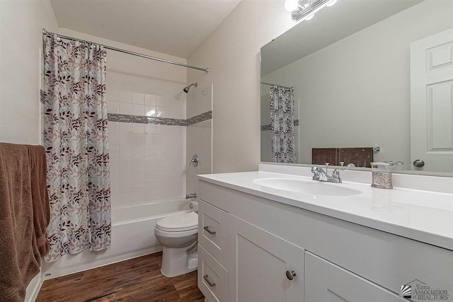 full bathroom with hardwood / wood-style flooring, vanity, toilet, and shower / bath combo with shower curtain