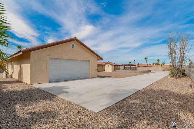 view of property exterior with a garage and an outdoor structure