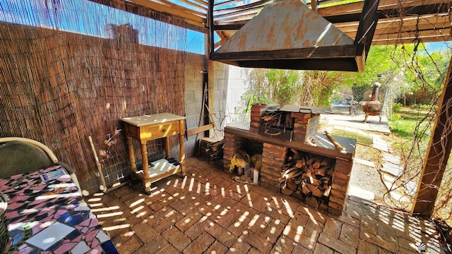 view of patio / terrace featuring an outdoor fireplace and a pergola