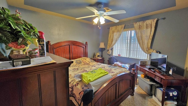 bedroom featuring a textured wall and ceiling fan