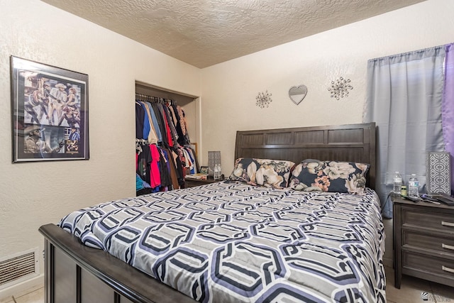 1127 S 13th Ave, Yuma, AZ 85364 - bedroom with a textured ceiling, tile patterned floors, and a textured wall