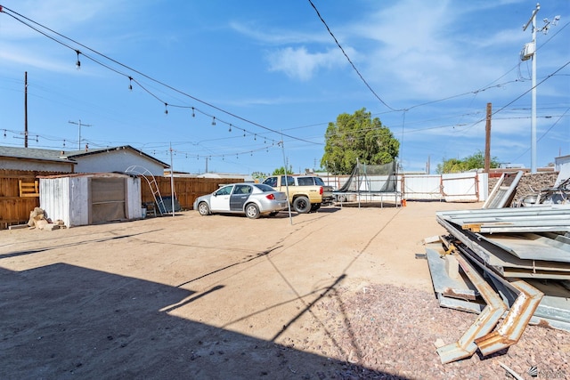 1127 S 13th Ave, Yuma, AZ 85364 - uncovered parking lot with a trampoline and a storage unit