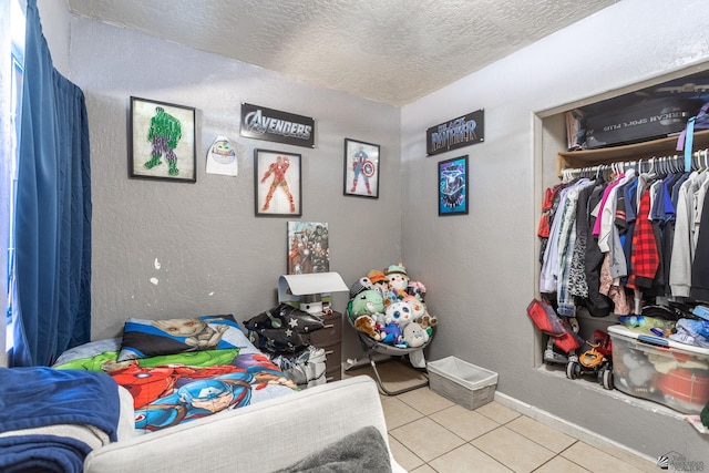 1127 S 13th Ave, Yuma, AZ 85364 - tiled bedroom featuring a textured ceiling and a closet