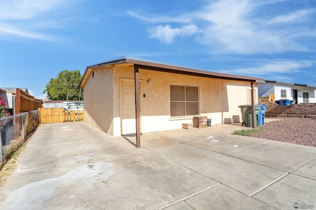 1127 S 13th Ave, Yuma, AZ 85364 - back of house with stucco siding and a patio