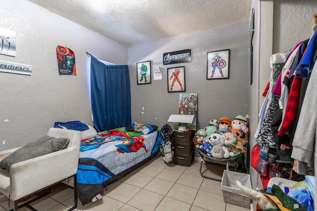 1127 S 13th Ave, Yuma, AZ 85364 - bedroom featuring light tile patterned floors, a textured wall, and a textured ceiling