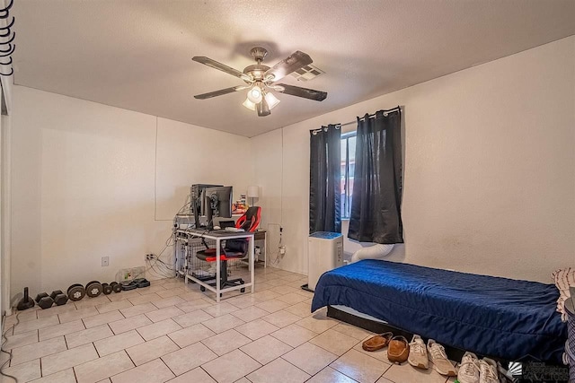 bedroom with tile patterned floors, ceiling fan, a textured ceiling, and visible vents