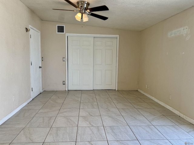 2741 S Fern Dr, Yuma, AZ 85364 - unfurnished bedroom with a closet, ceiling fan, light tile patterned floors, and a textured ceiling