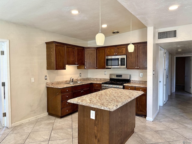 2741 S Fern Dr, Yuma, AZ 85364 - kitchen featuring stainless steel appliances, light tile patterned floors, a kitchen island, recessed lighting, and decorative light fixtures