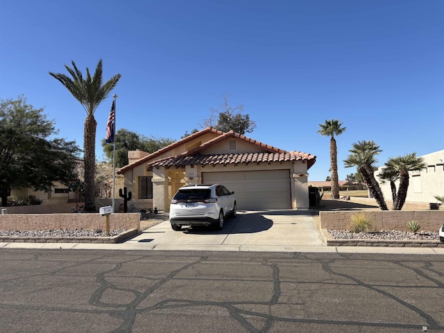 10218 S Del Rico, Yuma, AZ 85367 - view of front facade with a tiled roof, an attached garage, driveway, and stucco siding