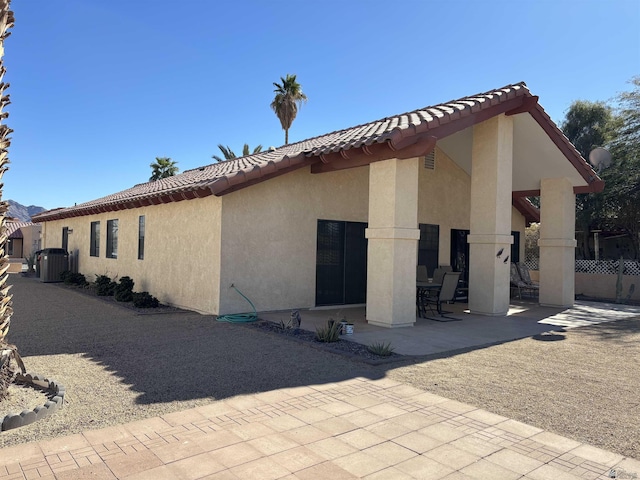 10218 S Del Rico, Yuma, AZ 85367 - view of side of property featuring fence, a tile roof, stucco siding, cooling unit, and a patio