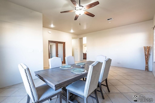 dining space with ceiling fan, visible vents, and light tile patterned floors