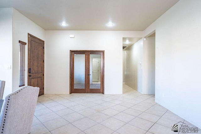 unfurnished room featuring light tile patterned floors, french doors, and recessed lighting