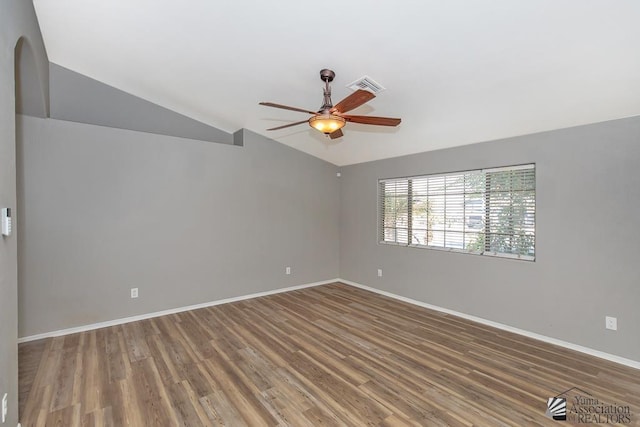 6257 E 47th St, Yuma, AZ 85365 - spare room featuring vaulted ceiling, ceiling fan, wood finished floors, and arched walkways