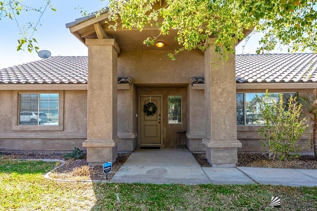 6257 E 47th St, Yuma, AZ 85365 - view of exterior entry featuring a tile roof and stucco siding